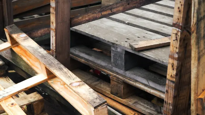 a pile of wooden pallets stacked on top of each other